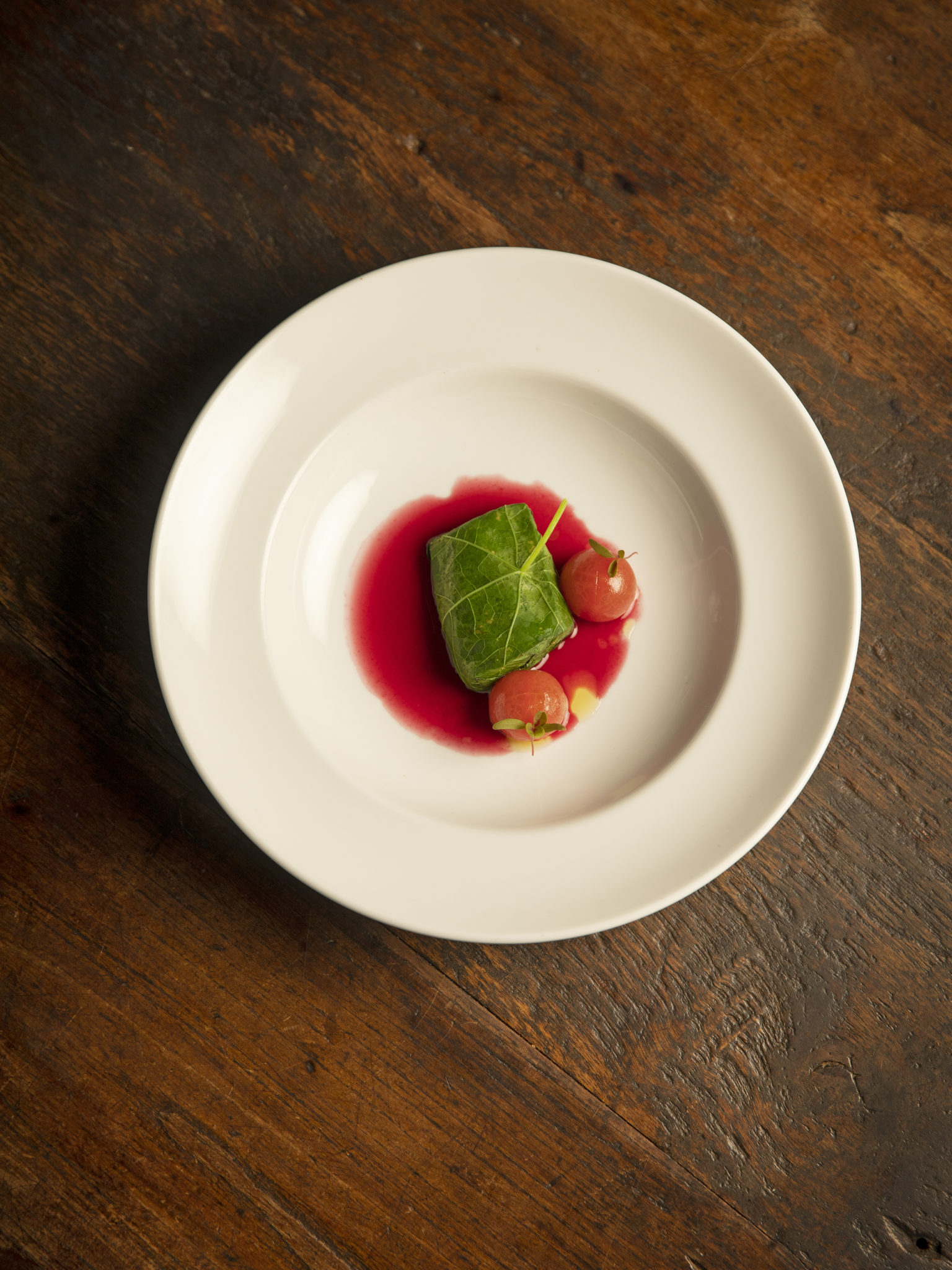Steamed Aquna Cod wrapped in nasturtium, confit tomatoes and beetroot dashi